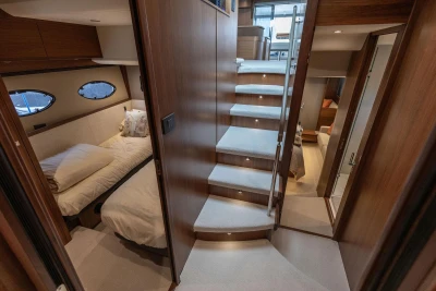Luxurious interior of 2017 Princess 52 yacht with elegant staircase and cozy bedrooms.