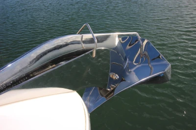 Shiny anchor on 2017 Princess 52 yacht against water background.