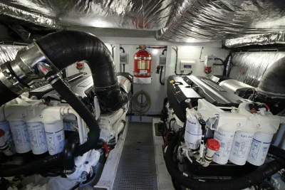 Engine room of a 2017 Princess 52 yacht, featuring dual engines and fire safety equipment.