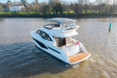 Luxury yacht Princess F50 2025 on a serene river.