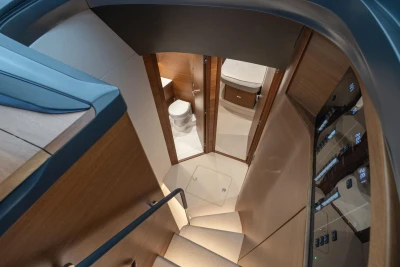 Interior view of 2022 Princess V55 yacht, featuring a staircase and modern bathroom.