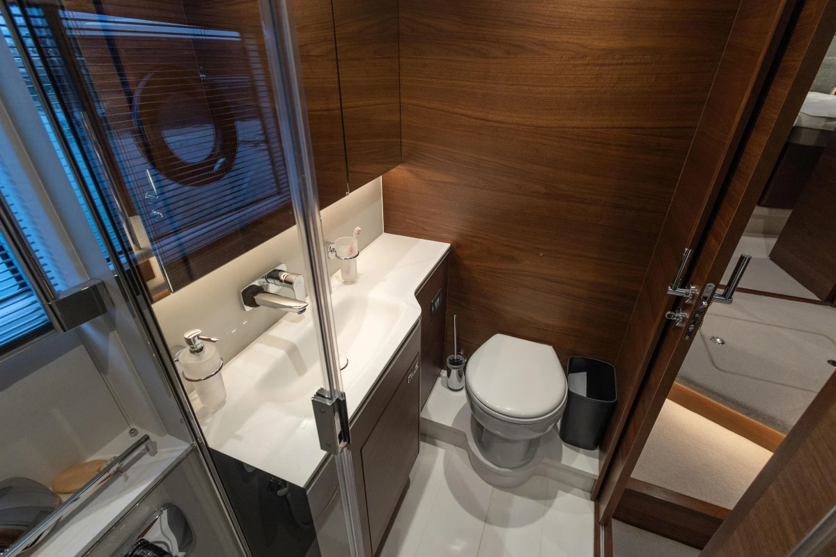 Luxurious bathroom in 2022 Princess V55 yacht with modern fixtures and wood paneling.