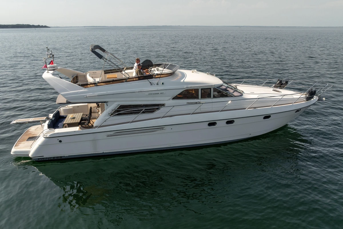Luxurious 1995 Princess 60 yacht cruising on calm waters.