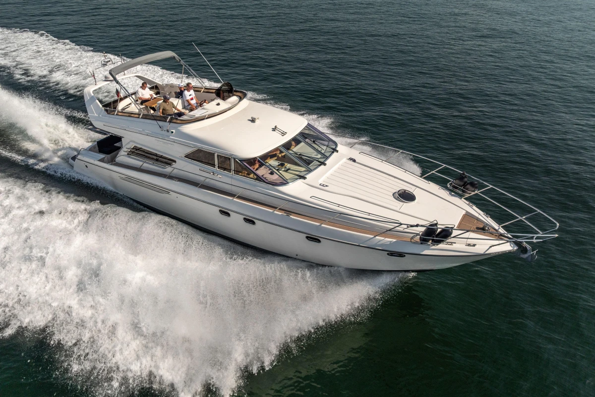 Luxurious 1995 Princess 60 yacht cruising swiftly on open water.