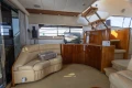 Luxurious interior of a 1995 Princess 60 yacht with leather seating and wooden cabinetry.