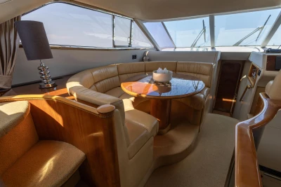 Luxurious interior of a 1995 Princess 60 yacht with elegant seating and wooden table.