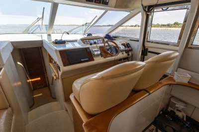 Interior of a 1995 Princess 60 yacht cockpit with leather seats and navigation equipment.