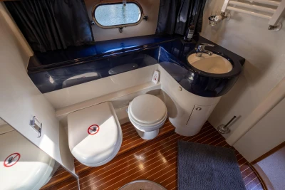 Bathroom interior of a 1995 Princess 60 yacht with modern fixtures and wooden flooring.
