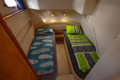 Cozy twin cabin in 1995 Princess 60 yacht with colorful bedding.