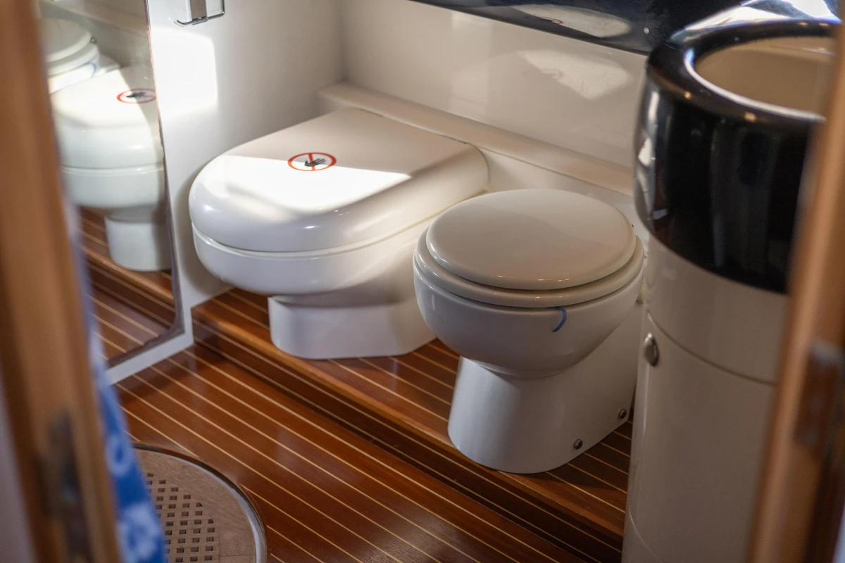 Bathroom interior of a 1995 Princess 60 yacht with wooden flooring.