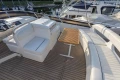 Luxurious 1995 Princess 60 yacht deck with white seating and wooden table.