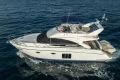 Luxury 2012 Princess 50 yacht cruising on open water, side view.