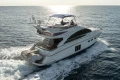 Luxury 2012 Princess 50 yacht cruising on open sea at sunset.