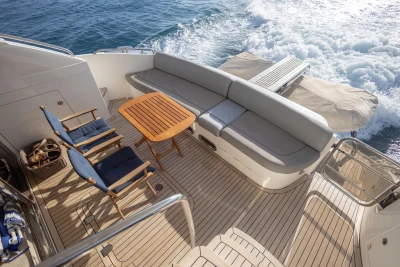 Luxurious 2012 Princess 50 yacht deck with seating, table, and ocean view.