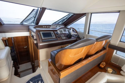 Interior helm of 2012 Princess 50 yacht with modern navigation equipment and luxurious seating.