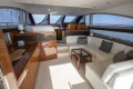 Luxurious interior of a 2012 Princess 50 yacht with elegant seating and panoramic windows.