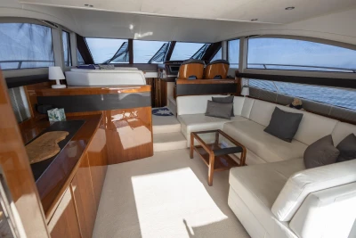 Luxurious interior of a 2012 Princess 50 yacht with elegant seating and panoramic windows.