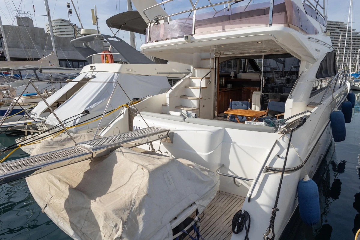 Luxury Princess 50 yacht, 2012 model, docked at marina with visible deck and seating area.