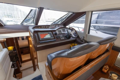 Luxurious 2012 Princess 50 yacht helm with modern navigation equipment and leather seating.