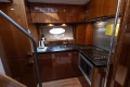 Luxurious kitchen interior of 2012 Princess 50 yacht with modern appliances and wood finish.