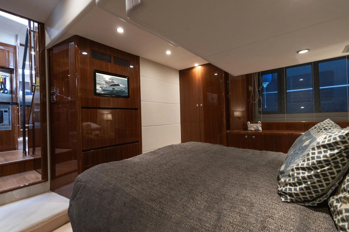 Luxurious cabin interior of 2012 Princess 50 yacht with modern furnishings and ambient lighting.