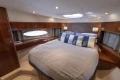 Luxurious bedroom interior of 2012 Princess 50 yacht with elegant wood finishes.