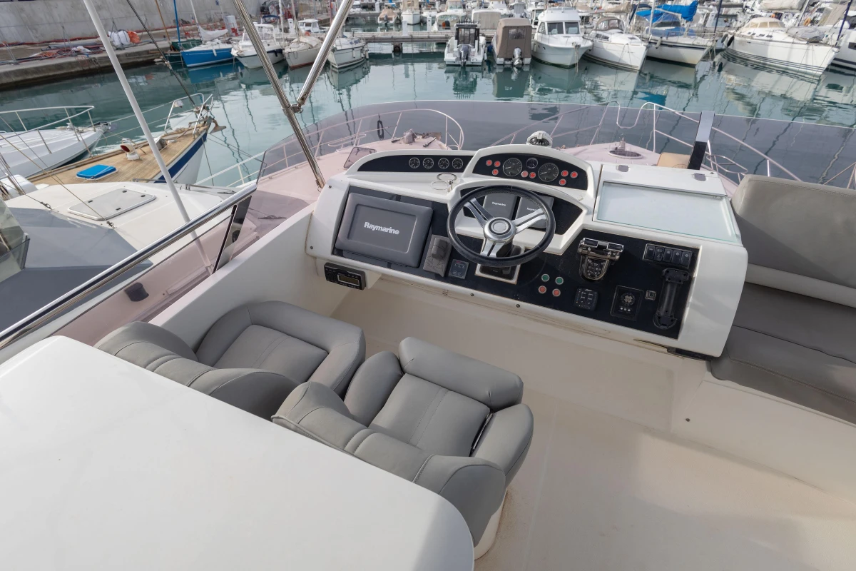 Helm of 2012 Princess 50 yacht with modern controls and comfortable seating.