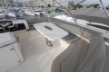 Luxurious 2012 Princess 50 yacht interior with elegant seating and table in a marina setting.