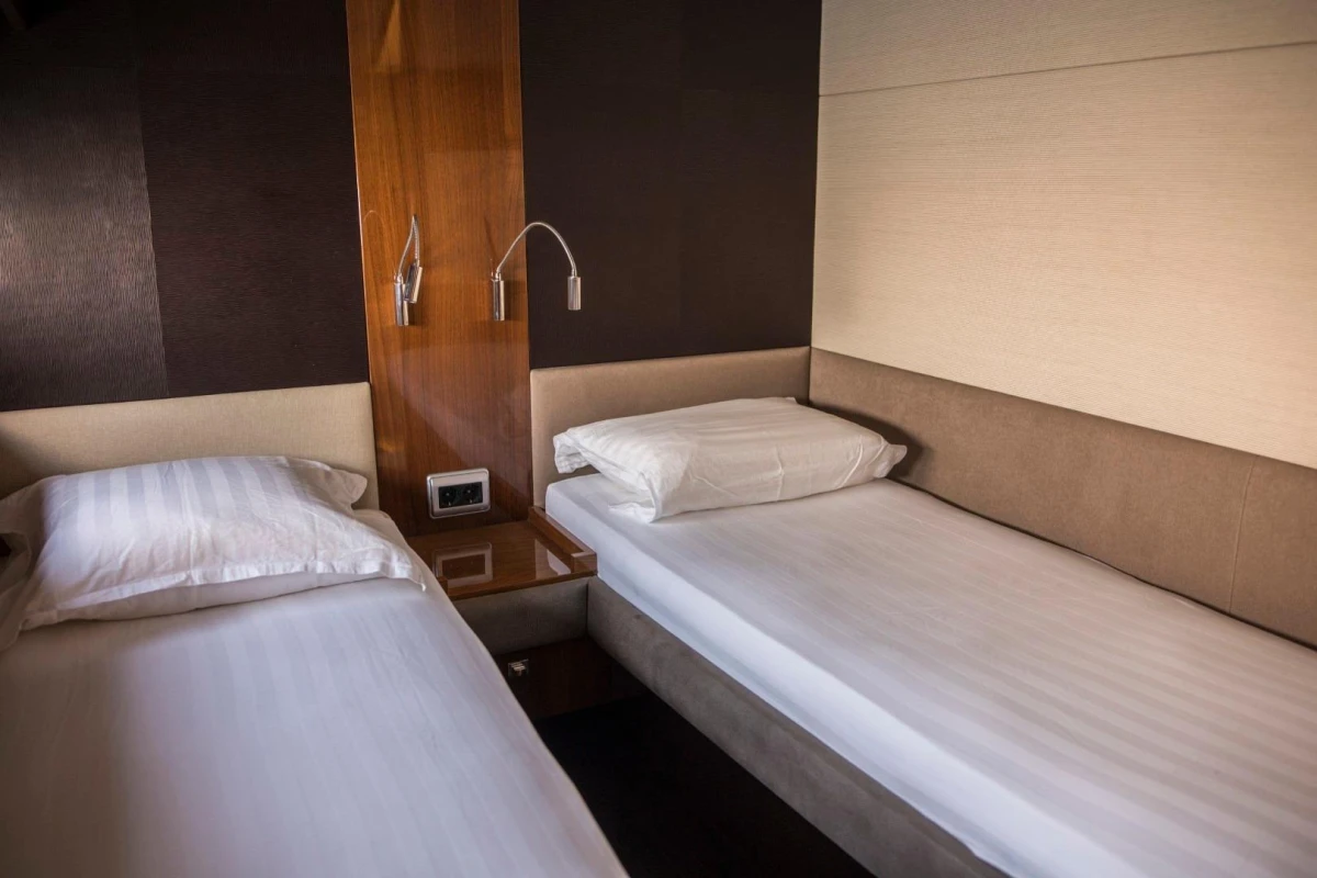 Interior of 2013 Princess 72 Motor Yacht with twin beds and modern decor.