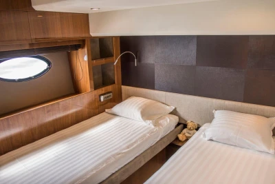 Luxurious twin bedroom in 2013 Princess 72 Motor Yacht with elegant wood paneling.