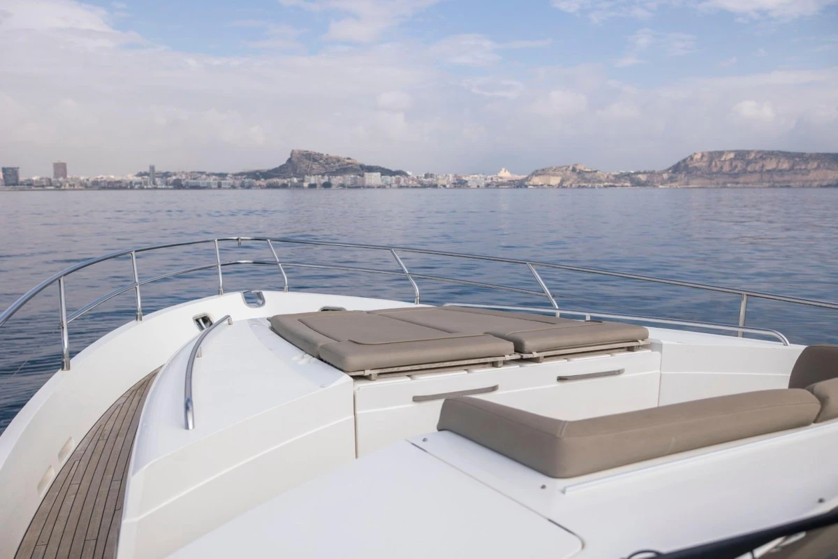 Luxurious 2013 Princess 72 Motor Yacht cruising with scenic coastal view.