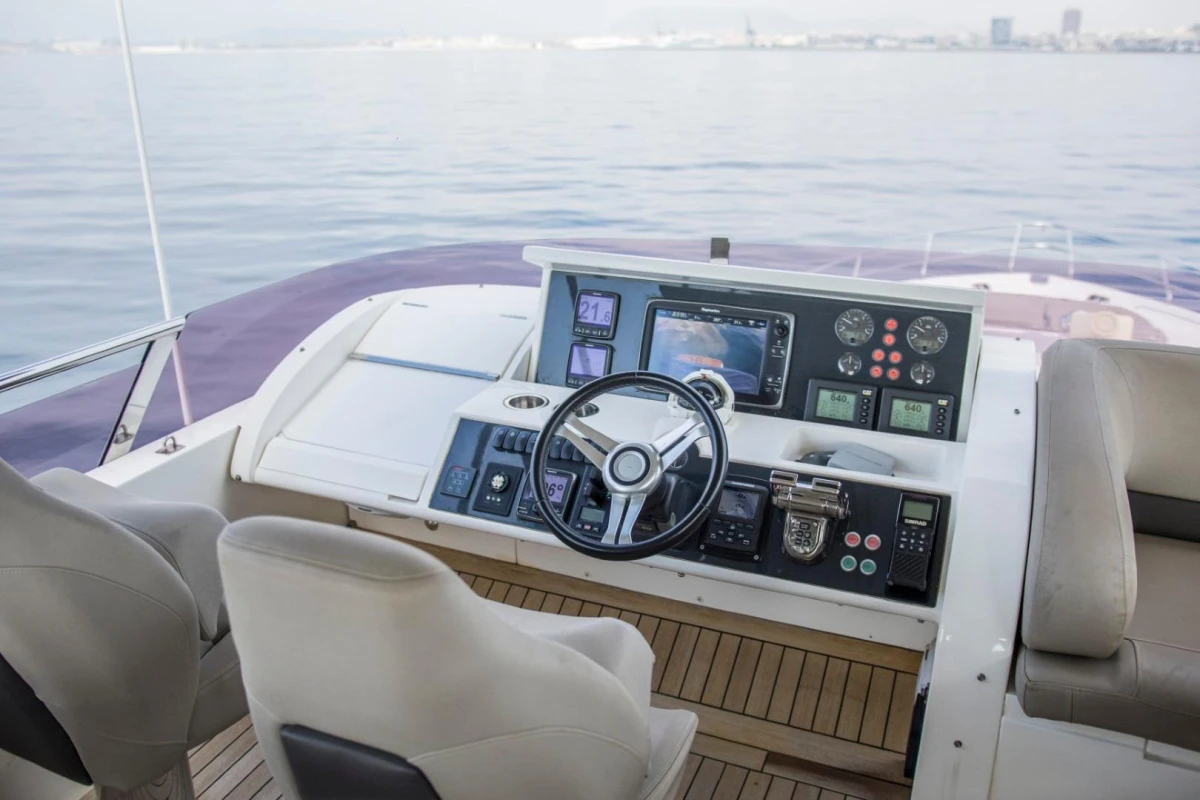 Helm of 2013 Princess 72 Motor Yacht with modern navigation controls and seating.