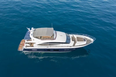 Aerial view of 2013 Princess 72 Motor Yacht cruising on calm blue waters.