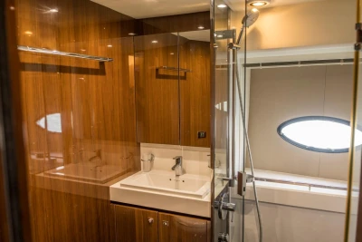 Luxurious bathroom interior of 2013 Princess 72 Motor Yacht with wood paneling and modern fixtures.
