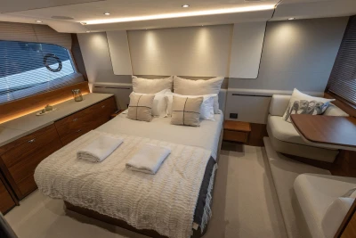 Luxurious 2020 Princess F62 yacht bedroom with elegant decor and cozy bedding.