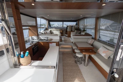Luxurious interior of 2020 Princess F62 yacht with modern kitchen and seating area.