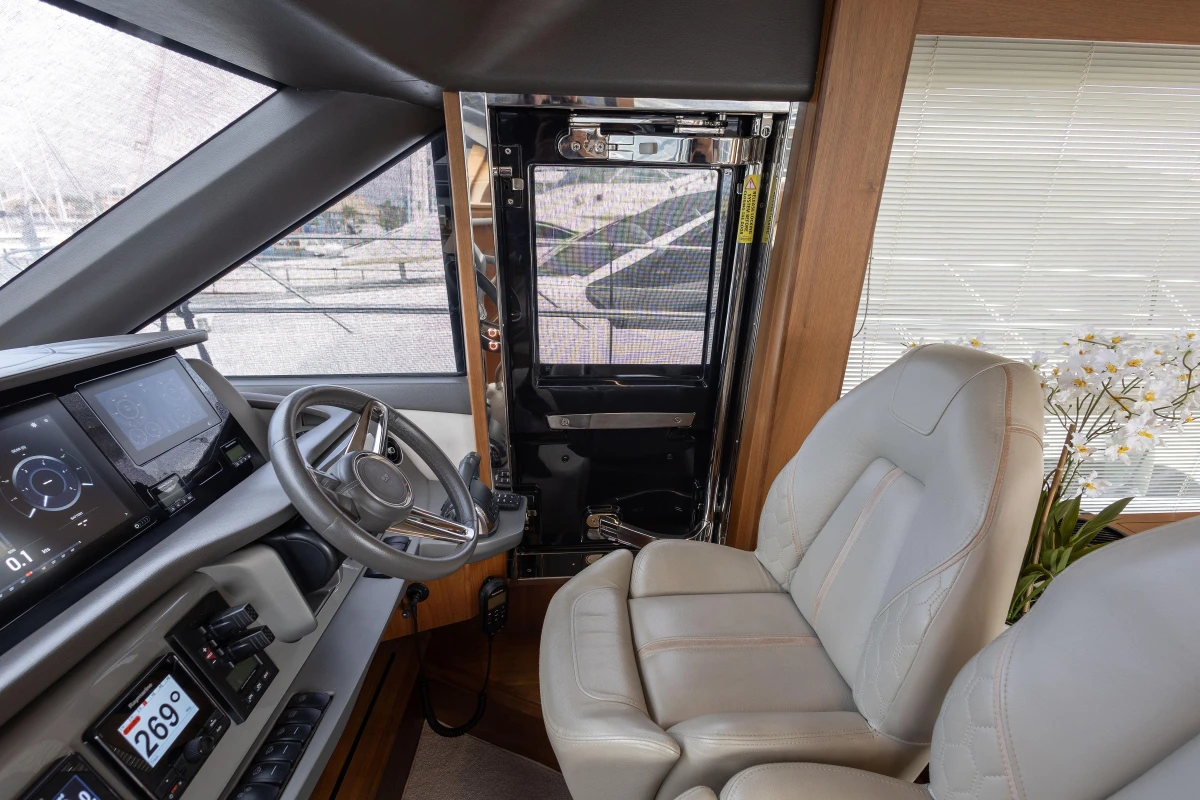 Luxurious 2020 Princess F62 yacht helm with modern controls and plush seating.