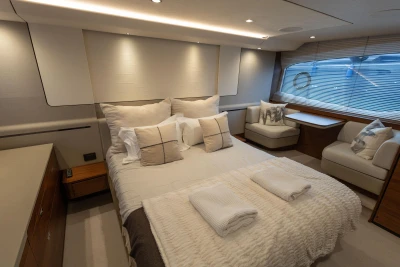 Luxurious bedroom interior of 2020 Princess F62 yacht with elegant furnishings and soft lighting.