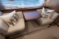 Luxurious 2020 Princess F62 yacht interior with elegant seating and wooden table.