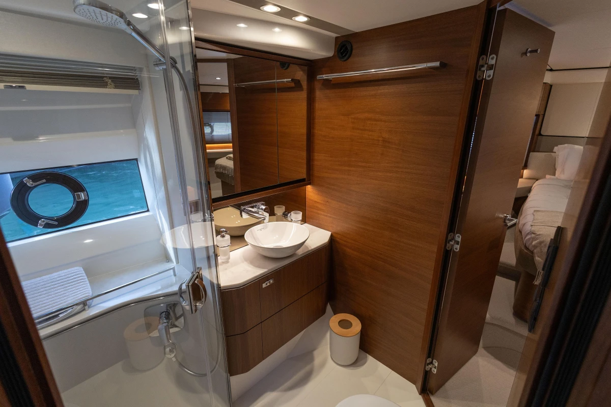 Luxurious bathroom interior of 2020 Princess F62 yacht with modern fixtures and wooden accents.