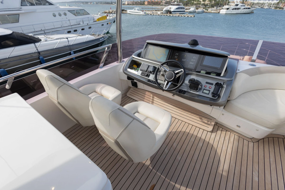 Luxurious 2020 Princess F62 yacht helm with modern controls and plush seating.