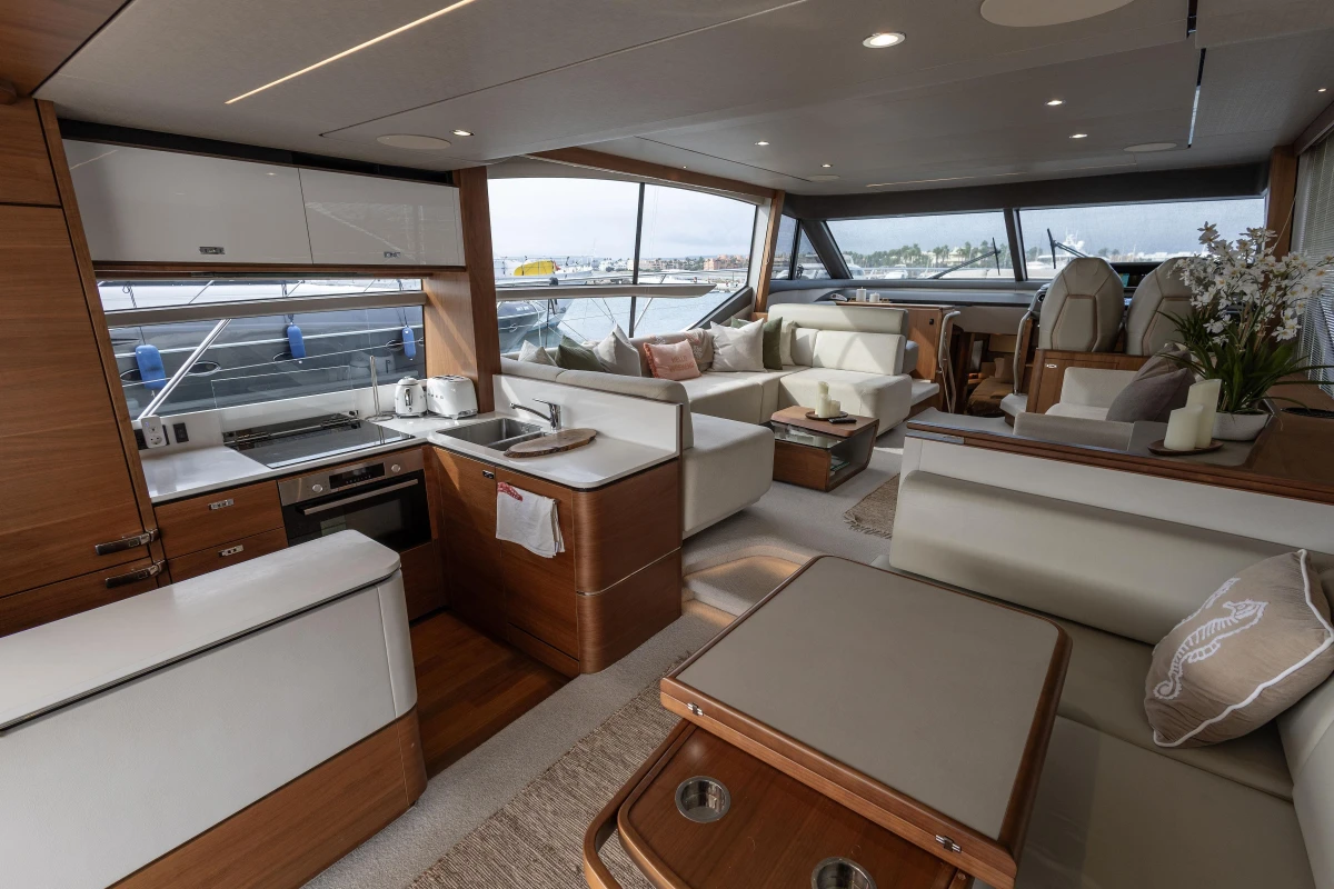 Luxurious interior of 2020 Princess F62 yacht with modern kitchen and spacious seating area.