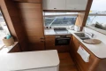 Modern kitchen interior on 2020 Princess F62 yacht with wood cabinetry and appliances.