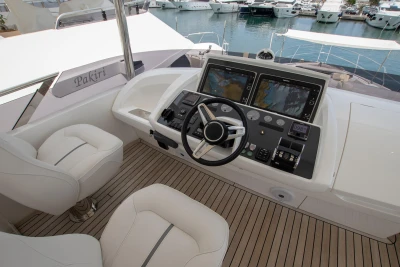 Helm of the 2016 Princess 68 yacht in a marina.