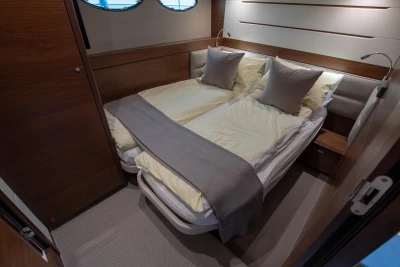 Cabin of the 2016 Princess 68 with a double bed and elegant decor.