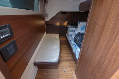 Cabin with two beds and wooden walls on a Princess 68 yacht.