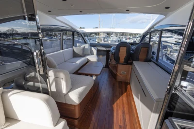 Luxurious interior of 2025 Princess V50 yacht with elegant seating and wooden flooring.