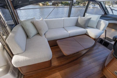 Luxurious interior of 2025 Princess V50 yacht with elegant seating and wooden flooring.