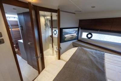 Luxurious interior of 2025 Princess V50 yacht featuring bedroom and bathroom.
