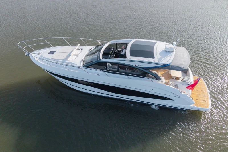 2025 Princess V50 yacht cruising on calm waters, showcasing sleek design and luxury features.